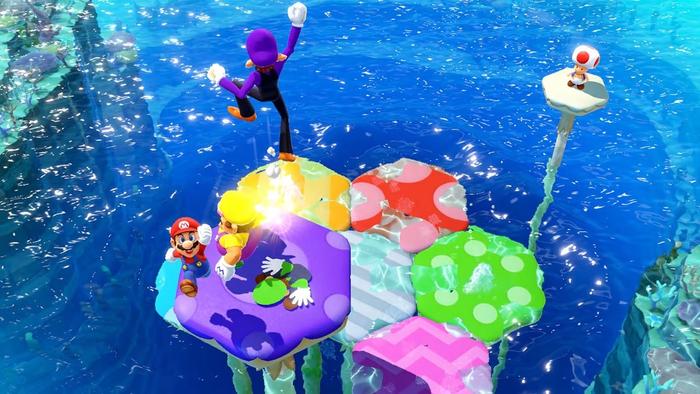 Mario Party Superstars screenshot - Mushroom Mix-up minigame. Mario and Wario on Purple mushroom, Waluigi jumping in the air, Luigi flattened.