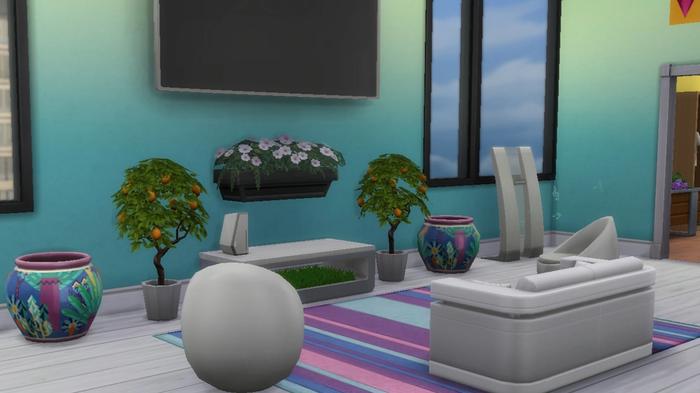 Sims 4. An Apartment Living Room That Is Fully Furnished. The image shows a blue living room that has white sofas and a tv hung on the wall. There are several indoor plants below the tv and a stripy rug under them.