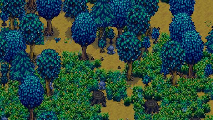 Stardew Valley. A dense area of trees, stumps and grass.