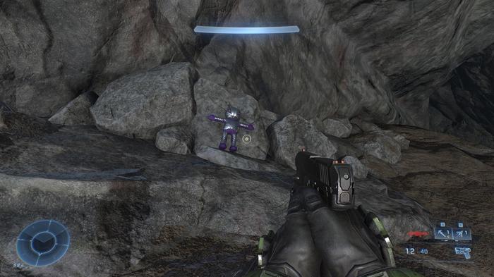 An arbiter doll is placed near a rock.