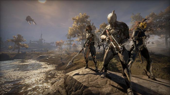 Image from Warframe of three characters standing on a hill.