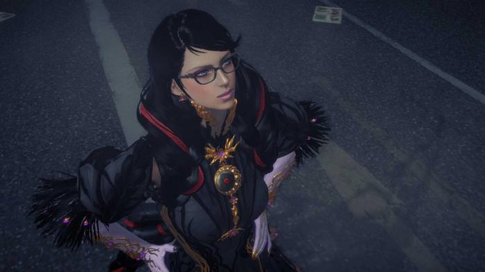 Bayonetta looking upwards with her hands on her hips.