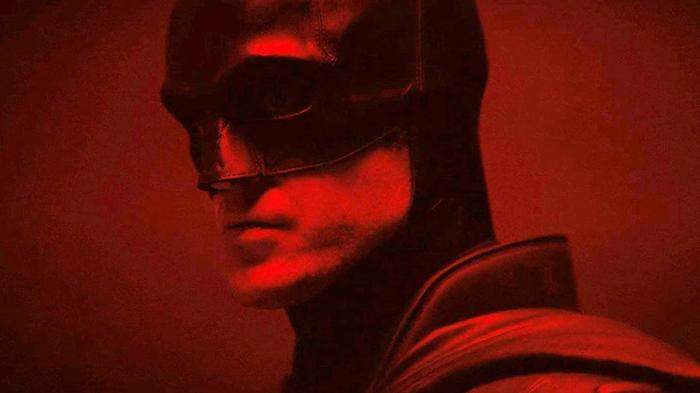 Close-up of the Batman's face in glowing, red light.