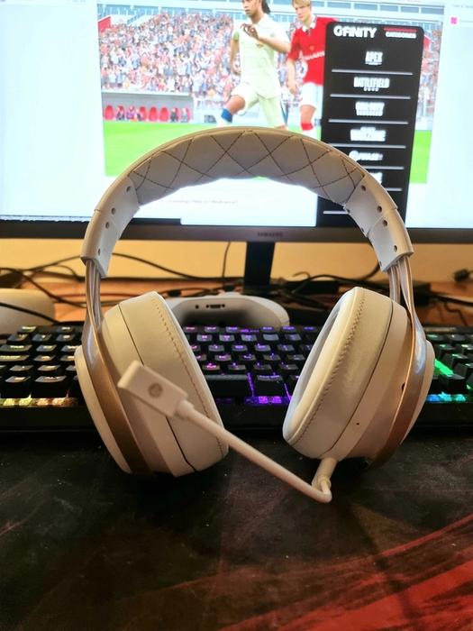LucidSound LS35X Wireless Gaming Headset on a desk. RGB keyboard and white Xbox Controller behind it, PC monitor with Gfinity Esports web page loaded up and FIFA 22 article.