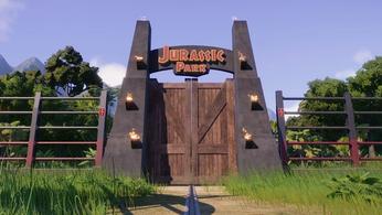 Jurassic World Evolution 2. The image shows the iconic Jurassic Park entrance gates. Jurassic Park is written across the top of the gate and the doors are wooden.