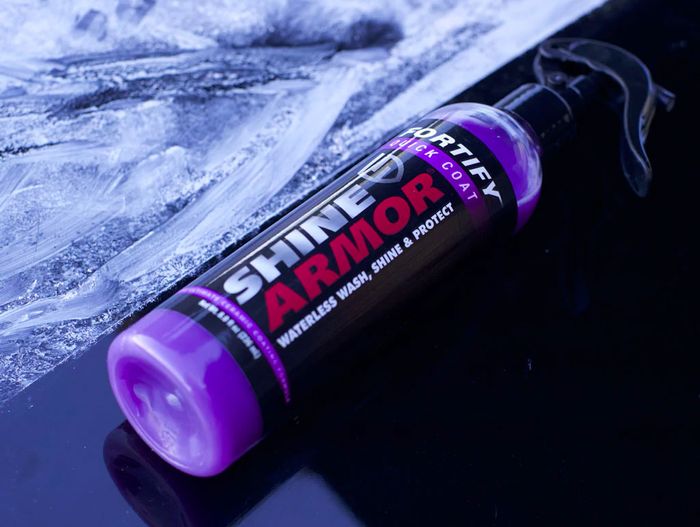 Best car wax spray Shine Armor product image of a clear spray bottle with a purple, black, and red label.