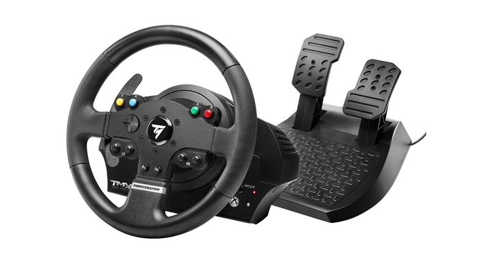 Best wheel for Forza Motorsport - Thrustmaster TMX product image of a black wheel featuring four coloured buttons and a white Thrustmaster logo in the centre next to a set of pedals.