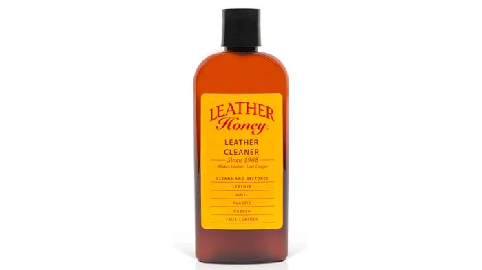 Best car leather cleaner Leather Honey product image of a brown bottle with a black cap and yellow labelling.