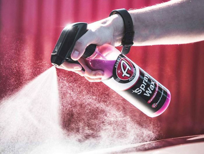 Best car wax spray Adam's Polishes Store product image of a clear spray bottle with a pink, black, and red label.