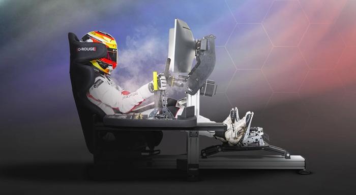 Latest racing setup news O-Rogue product image of a person sitting in an air-cooled racing seat in full racing gear including a yellow helmet.