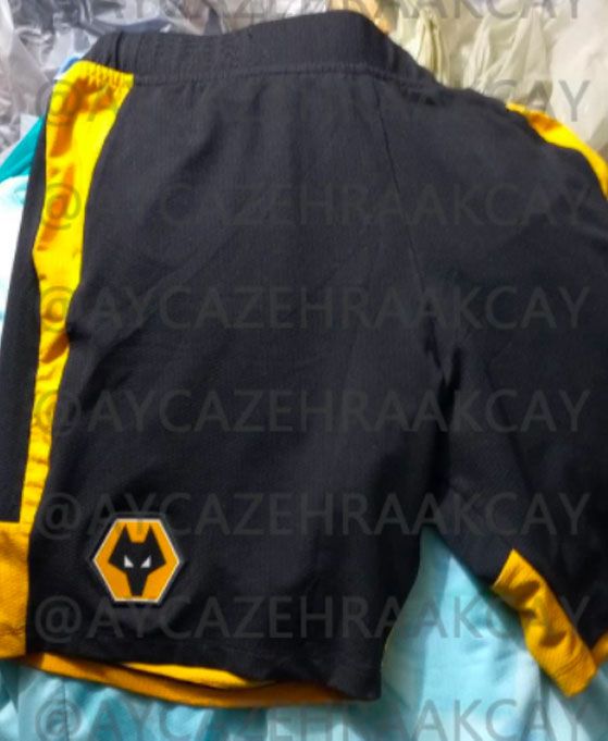 Wolverhampton Wanderers home kit 2022/23 product image of a pair of black shorts with amber details.