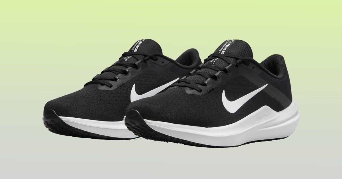 A pair of black running shoe featuring white midsoles and white Swooshes on the sides in front of a gradient background.