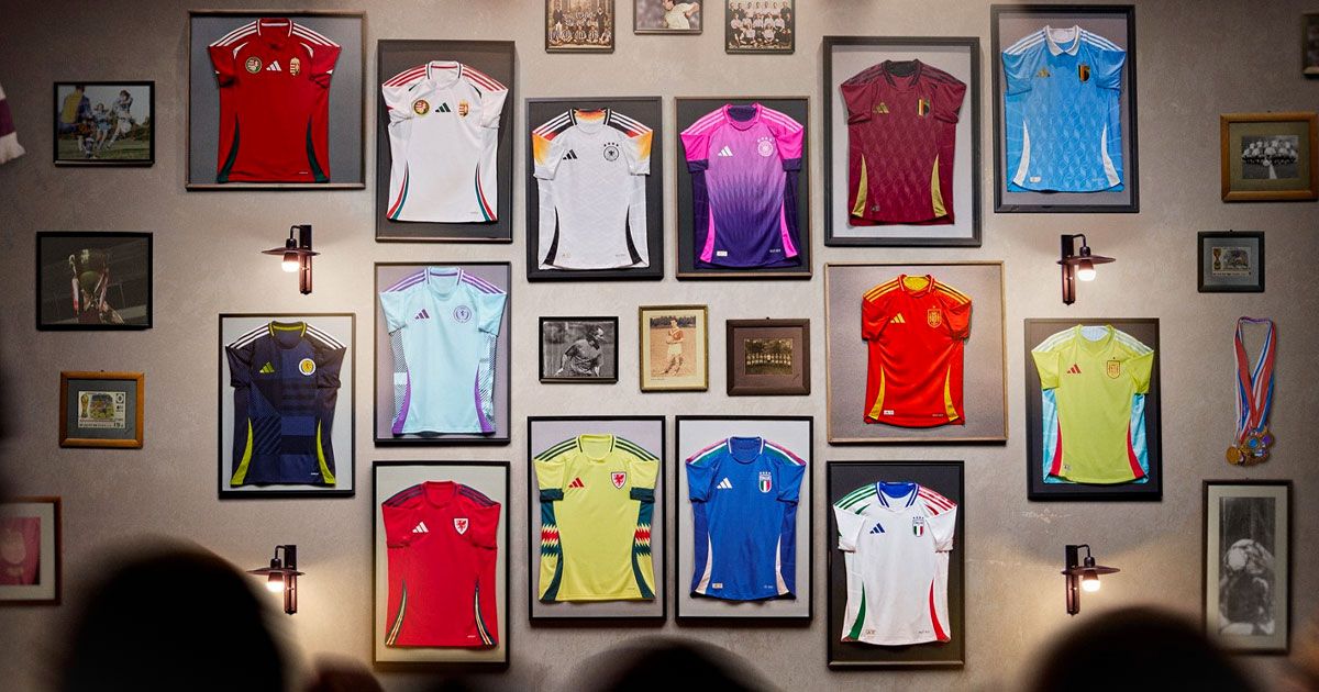 A collection of framed adidas football shirts from Euro 2024 on a beige wall.
