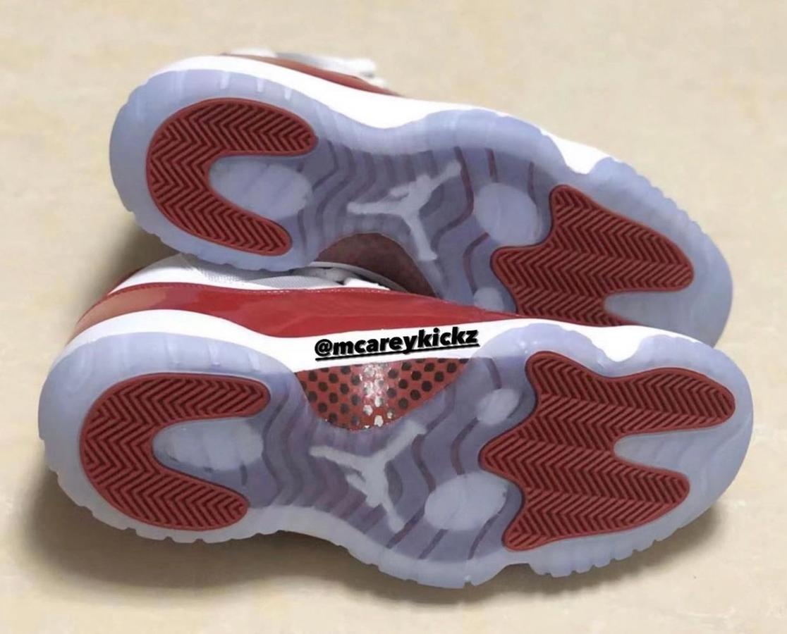 Air Jordan 11 Retro "Cherry" image of a white and cherry red pair of mid-top sneakers.