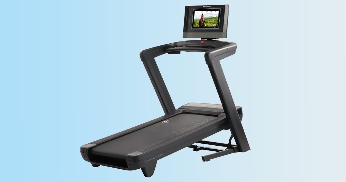A black treadmill featuring a screen in front of a gradient blue background.