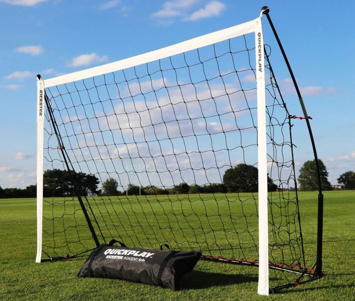 A foldable goal out on a field.