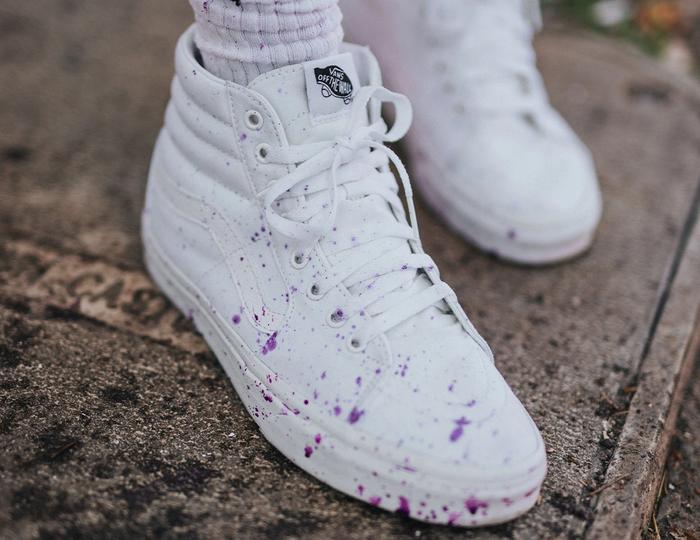 Vans product image of white Skate-His with purple paint splattered over the top.