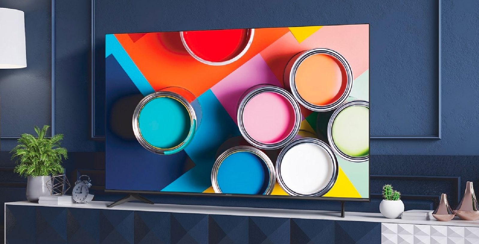 Hisense 55A6G product image of a TV with open buckets of paint on its display.