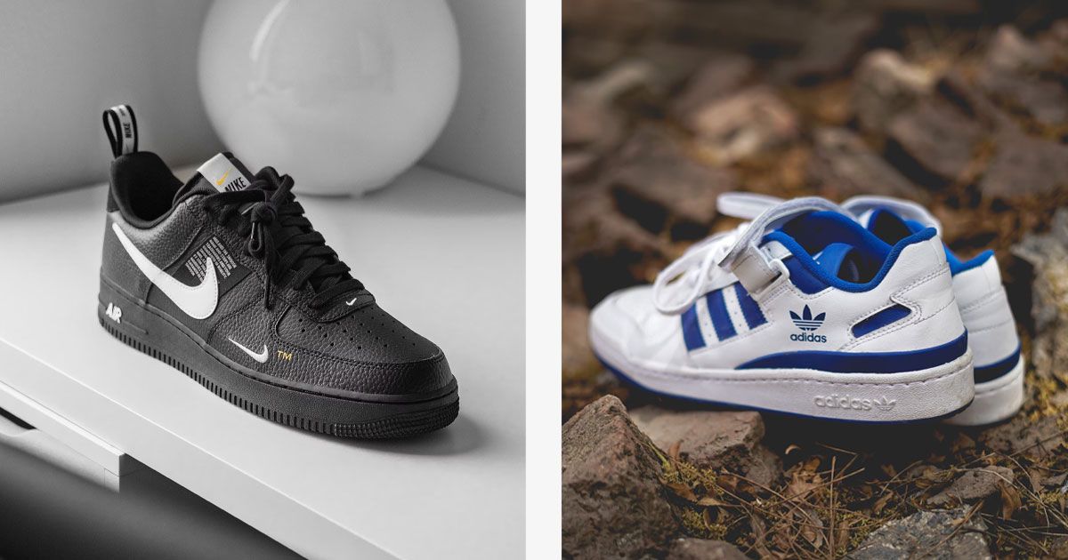 A black Air Force 1 x Off White collab sneaker on the left. On the right, a pair of white adidas Forums with blue details sat on some rocks.