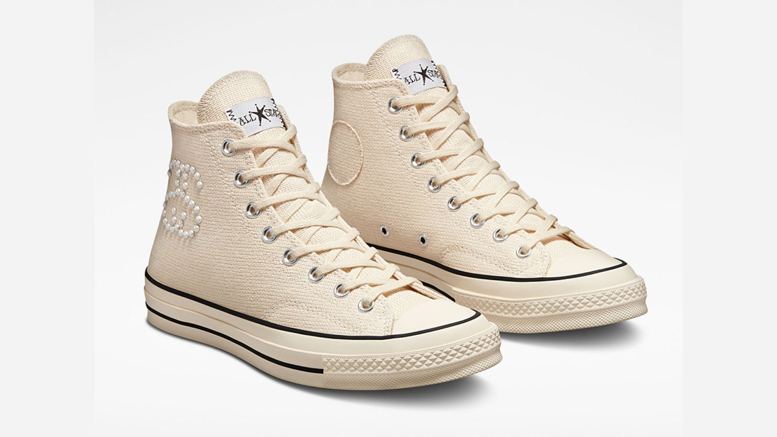Stüssy x Converse Chuck 70 Hi "Fossil Pearl" product image of a fossil white Converse high-top featuring the Stüssy logo on the side made from white pearls.