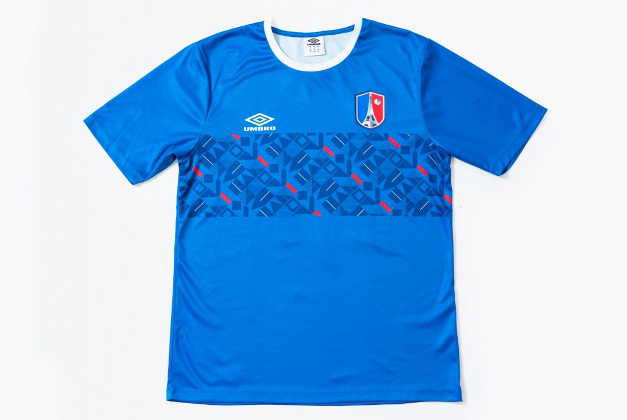 The Nations' Collection by Umbro product image of a blue retro France shirt with a red and navy geometric pattern across the centre.