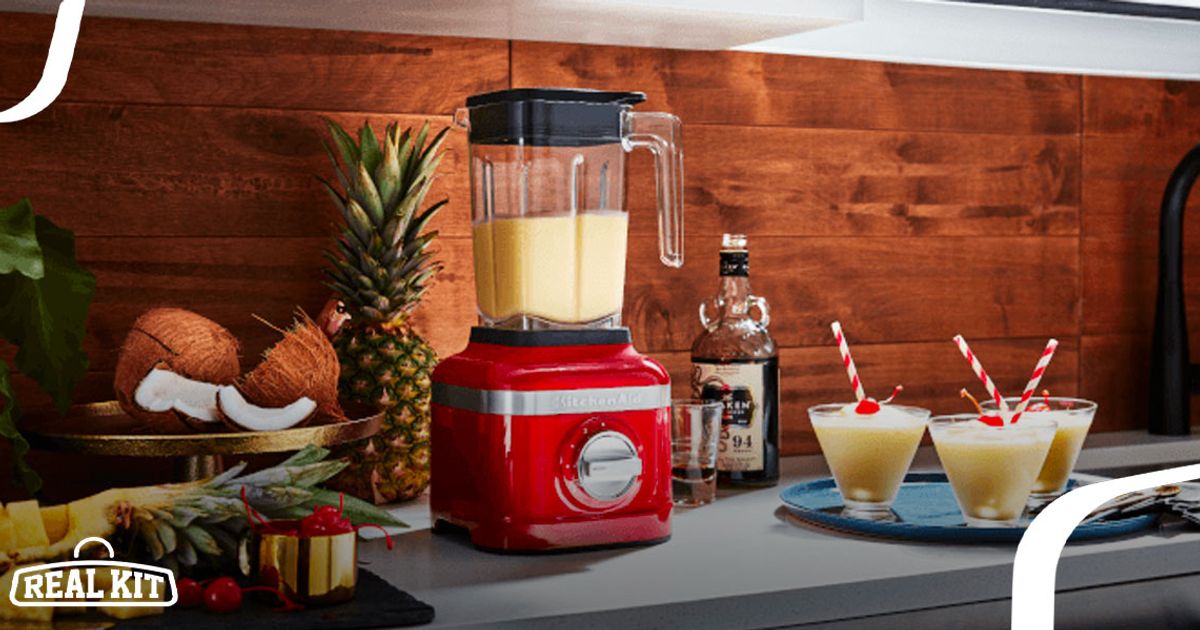 Image of a red blender on a kitchen side with a yellow mixture in the jug.