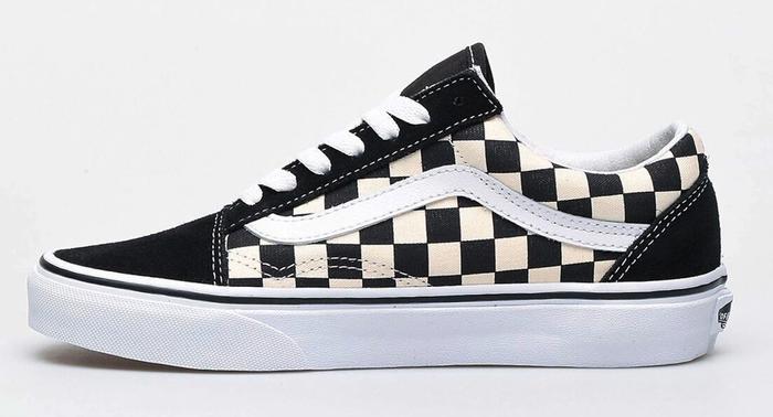 Vans Old Skool Primary Check product image of a single black sneaker with a white and black checkered pattern.