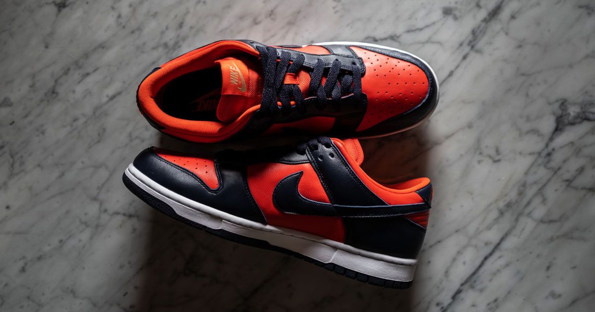 Image of dark navy blue and bright red Nike Dunks with white midsoles.