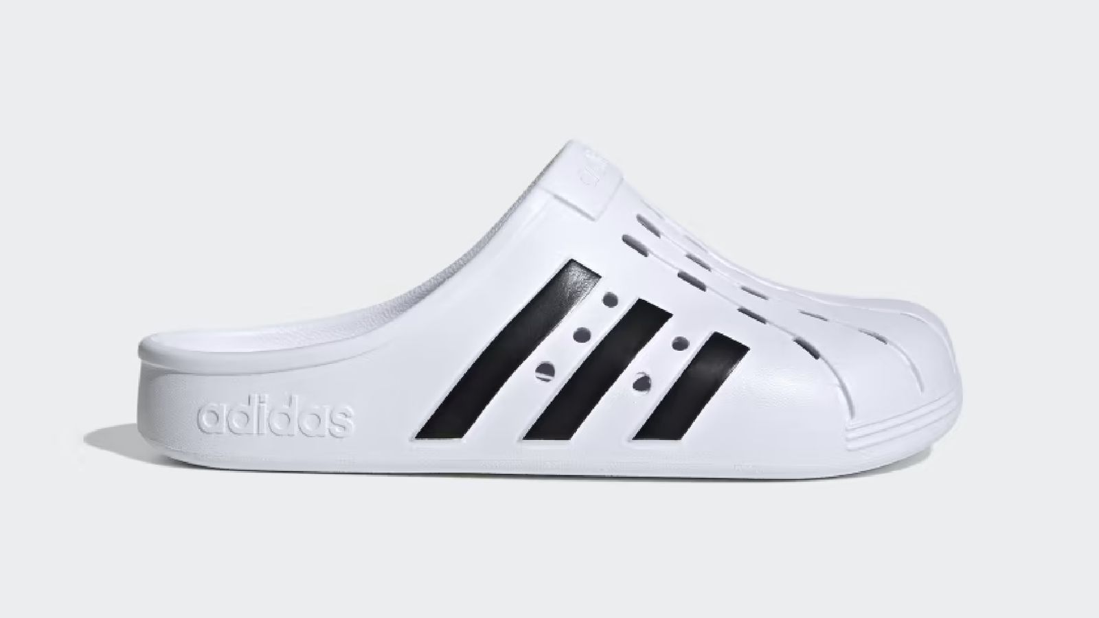 adidas Adilette Clogs product image of a white slip-on shoe with three black stripes down the side.