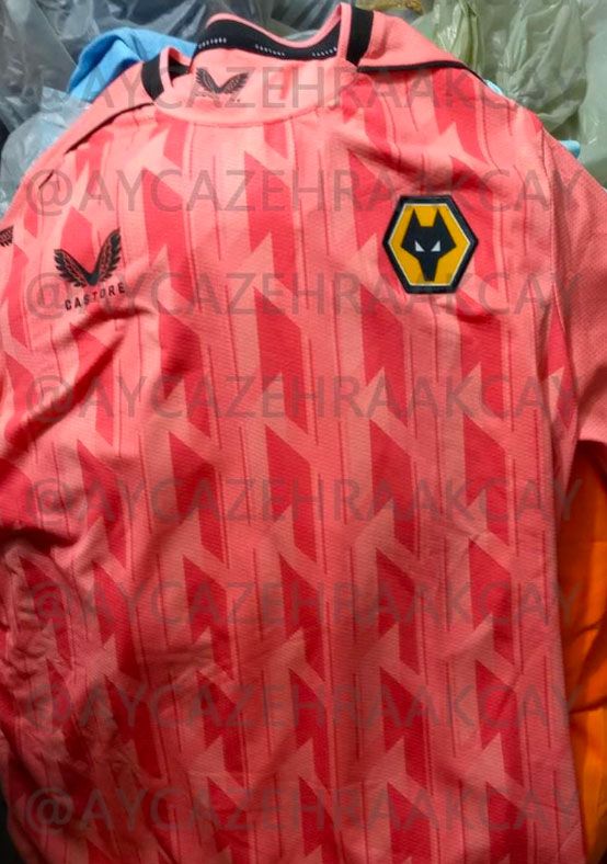 Wolverhampton Wanderers third kit 2022/23 product image of a salmon pink shirt with black details.