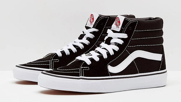 Vans Sk8-Hi product image of a pair of black high-tops with white rubber midsoles and accents.