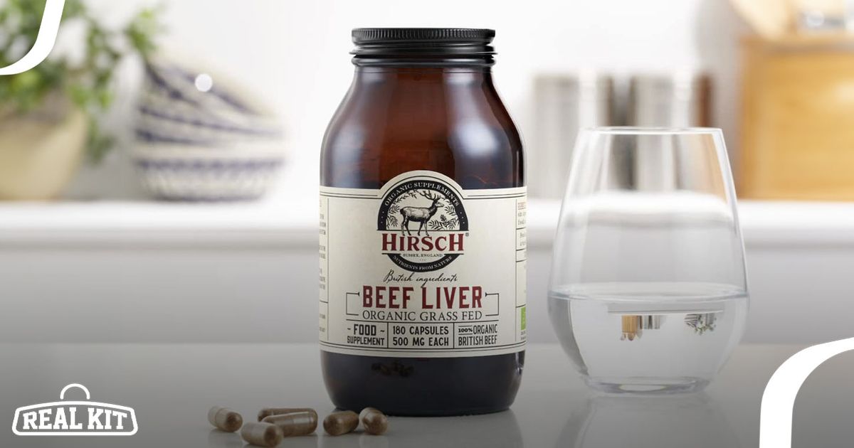 Image of a brown vitamin container with light cream and dark red branding in front of brown beef liver capsules and next to a glass of water.