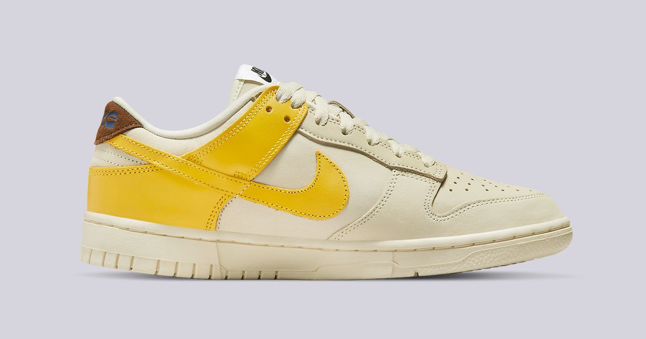 Nike Dunk Low "Banana" product image of an off-white leather sneaker with yellow overlays.