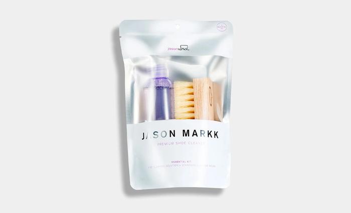 Best shoe cleaning kit - Jason Markk product image of a silver packet containing purple cleaning solution and an orange brush.
