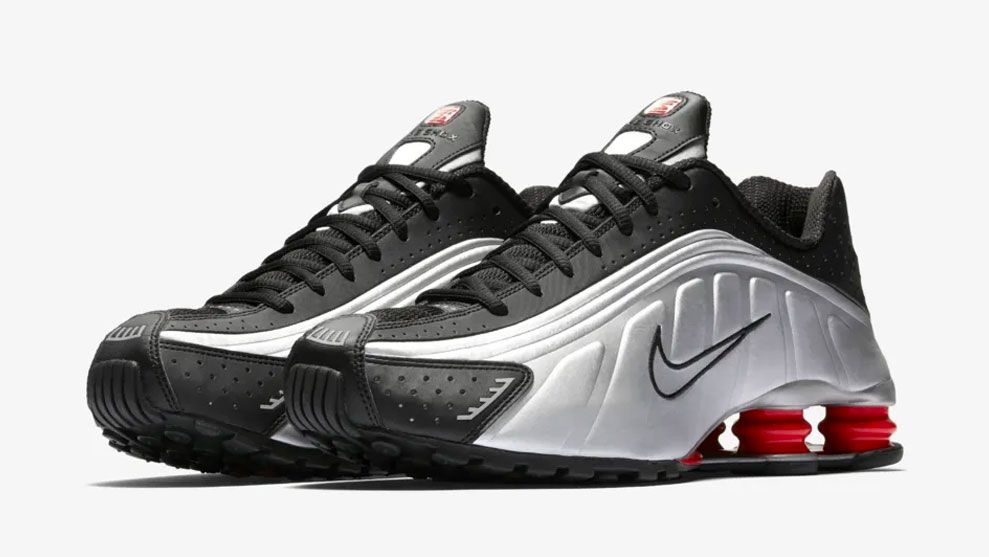 Nike Shox R4 Black "Metallic Silver" product image of a silver and black sneaker with red cushions towards the heels.