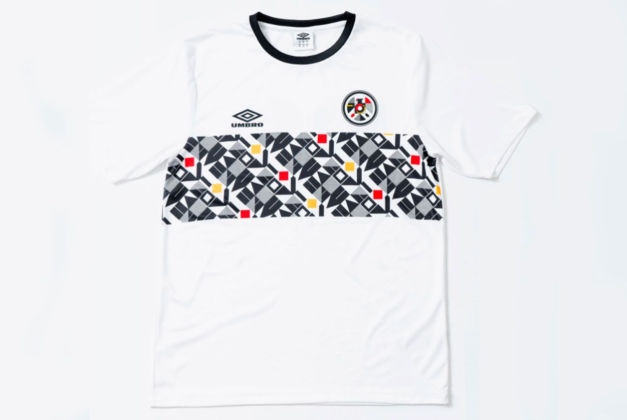 The Nations' Collection by Umbro product image of a white retro Germany shirt black, grey, yellow, and red geometric pattern across the centre.