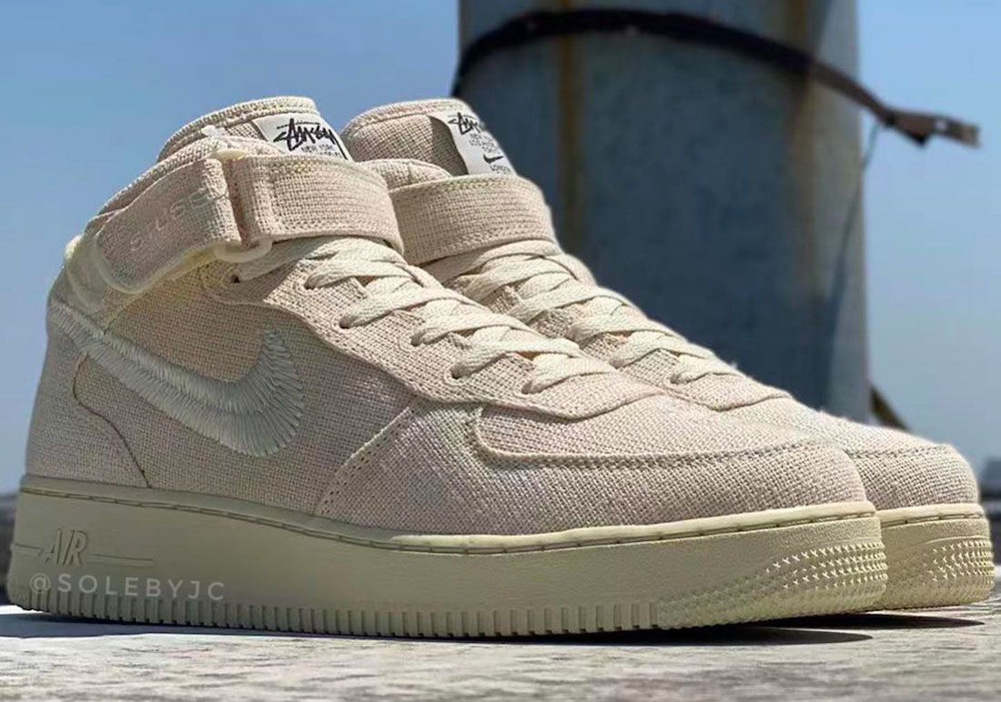Stussy x Nike Air Force 1 Mid "Fossil" product image of Sail hemp coloured sneakers.