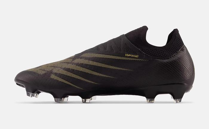 Best football boots New Balance product image of a singular black boot with gold NB-branded details.