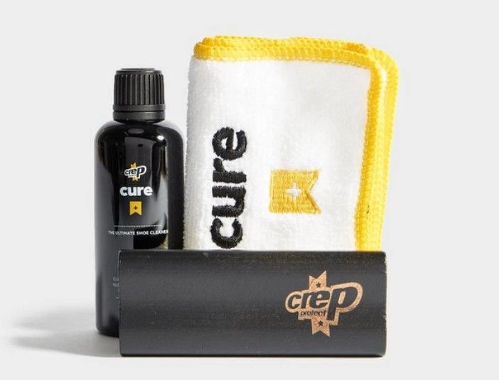 Crep Protect Cure product image of a black bottle, brush, and white cloth with yellow details.