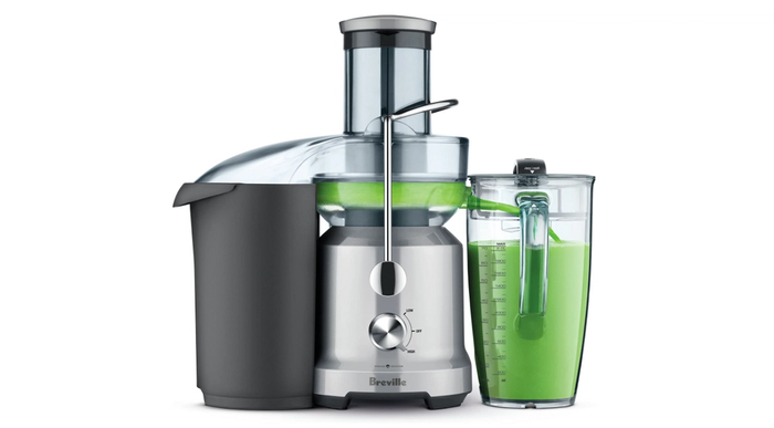 Best juicer Breville product image of a silver and grey machine creating a green juice.