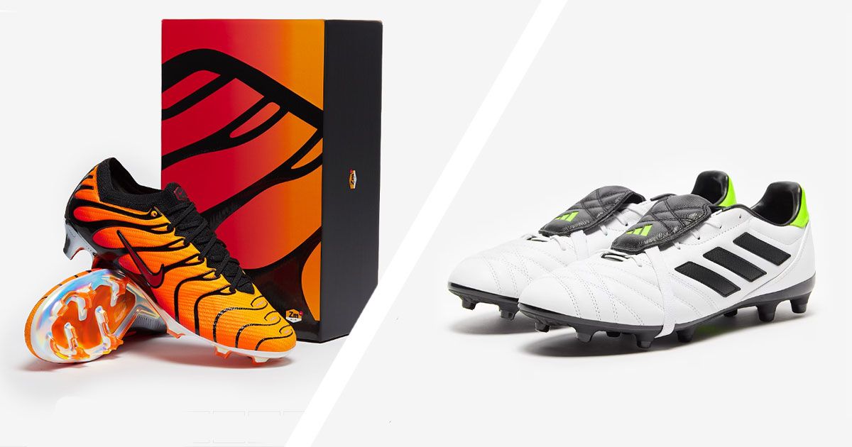 A pair of black and orange Nike football boots in front of a matching box on one side of a white line. On the other, a pair of white and black adidas football boots with green trim.