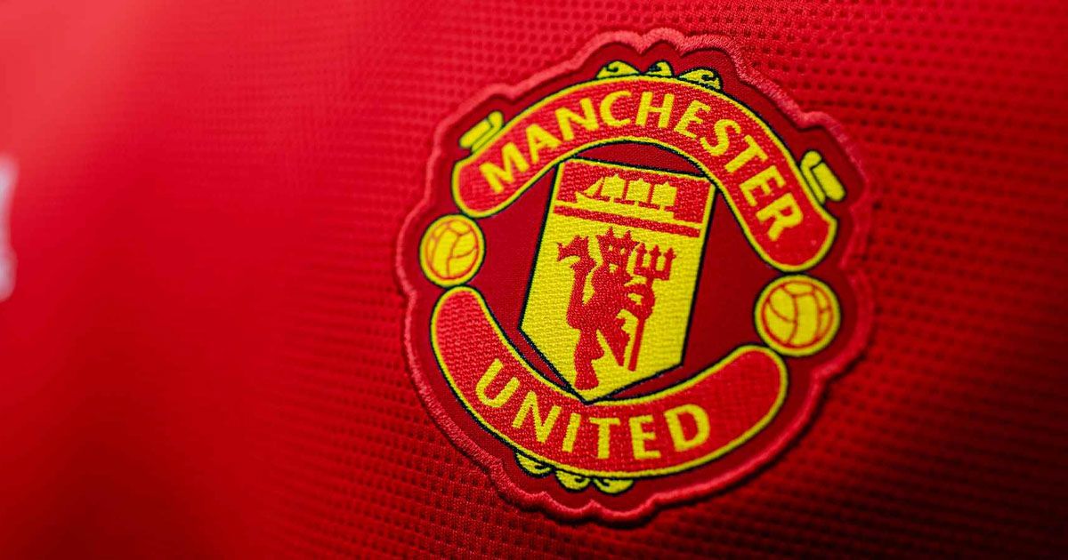 A red Manchester United kit close-up on the yellow and red badge.