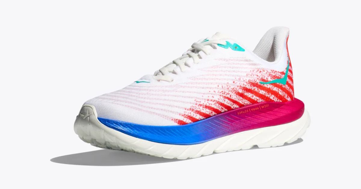 A white running shoe with a gradient blue and pink midsole, turquoise accents, and paint-splattered stripes in red down the sides.