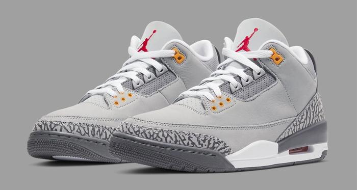 Best Air Jordan 3 colorways "Cool Grey" product image of a pair of light grey sneakers with red and orange details.