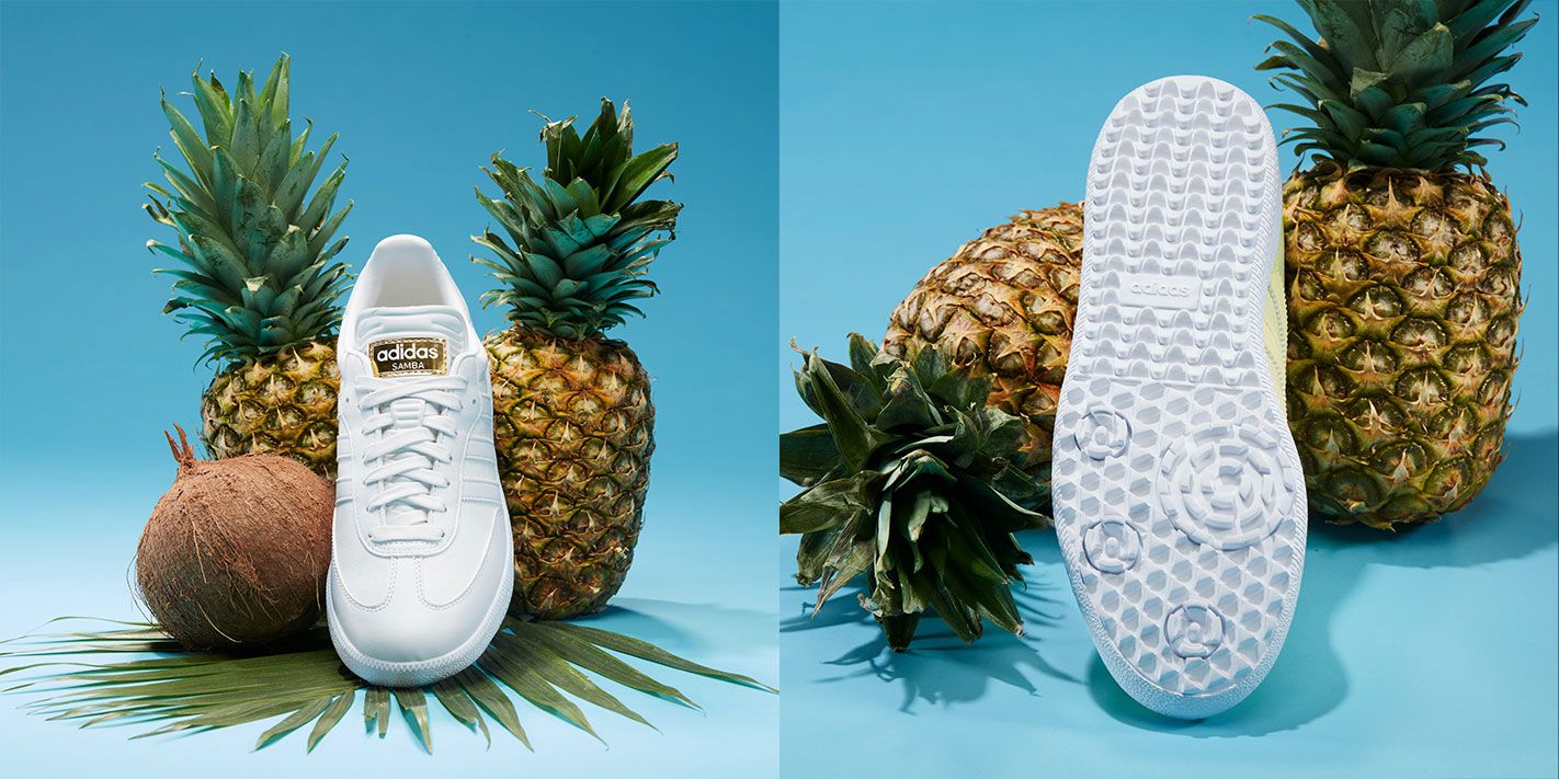 adidas Samba Golf product image of the crystal white colourway leaning against pineapples.