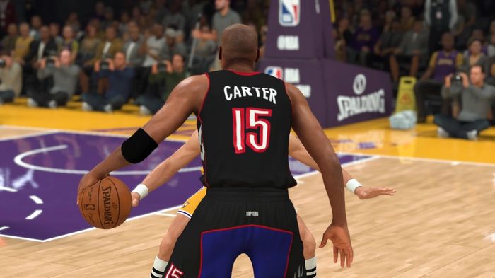 Raptors-era Vince Carter sizes up a Laker's guard during a 2K21 game.
