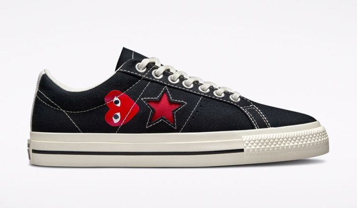 COMME des GARÇONS x Converse One Star Ox product image of a black and white low-top with a red heart and star on the side.