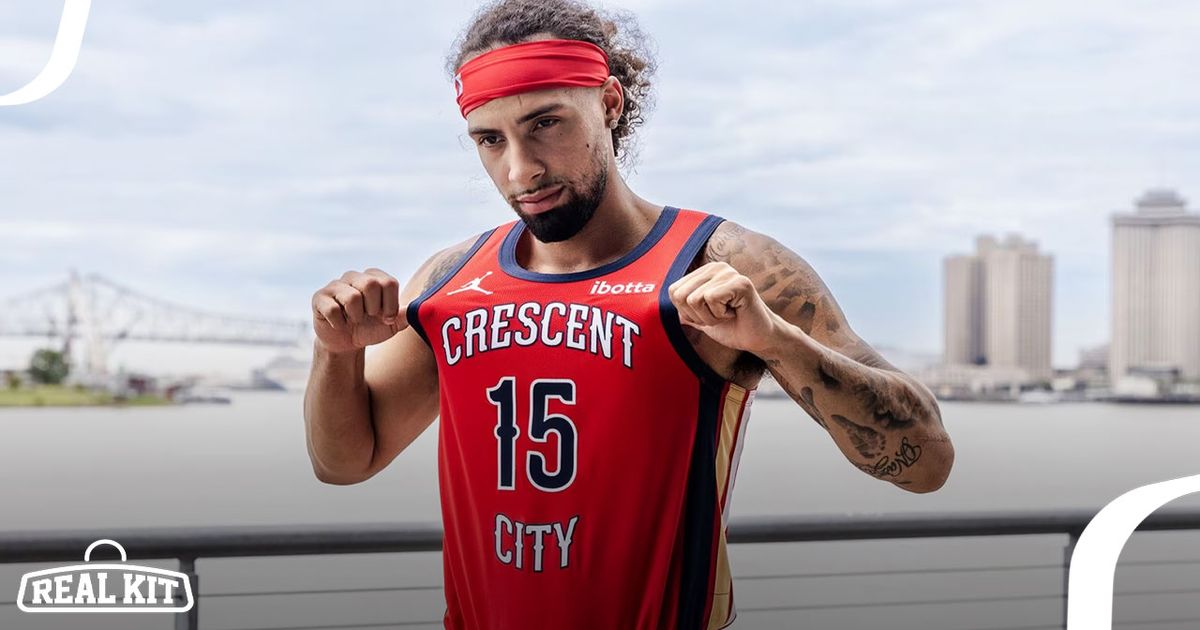 Someone in a red headband wearing a red NBA jersey with navy trim and Crescent City printed in white across the front.