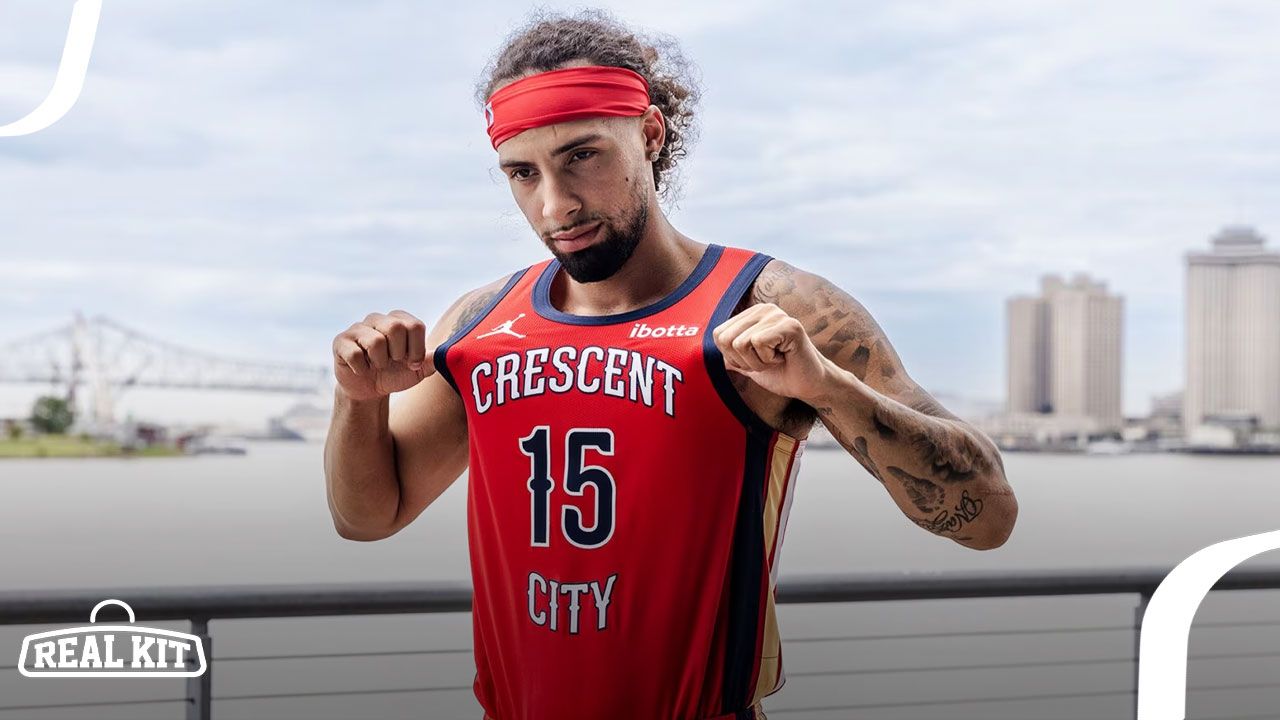 Someone in a red headband wearing a red NBA jersey with navy trim and Crescent City printed in white across the front.