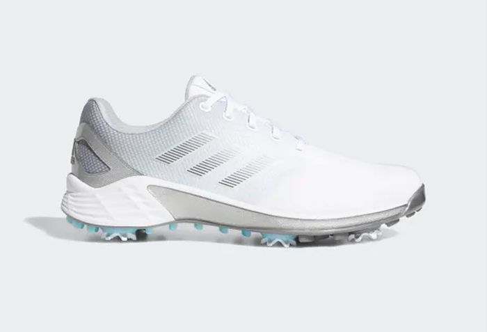 Best golf shoes adidas product image of a pair of white trainers that fade into a grey.